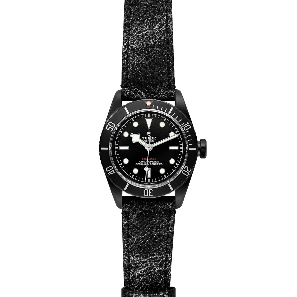 Black watch with a textured strap on a white background
